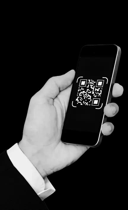 Hand holding a mobile phone displaying a QR code